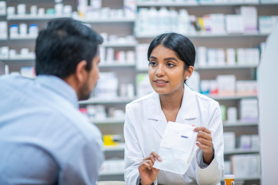 Pharmacist consulting patient